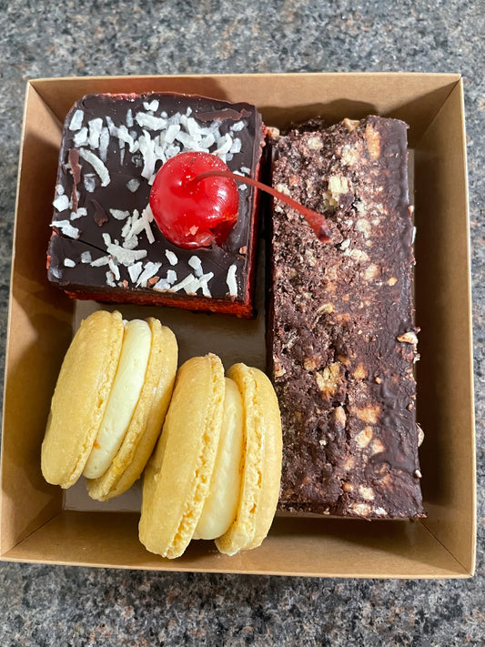 1x Single Serve Cherry Ripe Slice & 1x Single Serve Chocolate Hazelnut Hedgehog Slice. 2x macarons