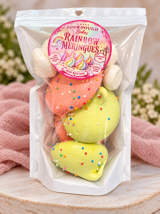 Sweet Sourdough Bakes rainbow meringues in a pastel-styled product photograph